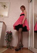 Girl lets her skirts fly up exposing her legs in black hose and spike heels