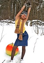 Sporty upskirt gal in black pantyhose playing with fitness ball in the snow