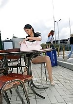 Risky babe in expensive shiny tights boldly flashing butt in a public place